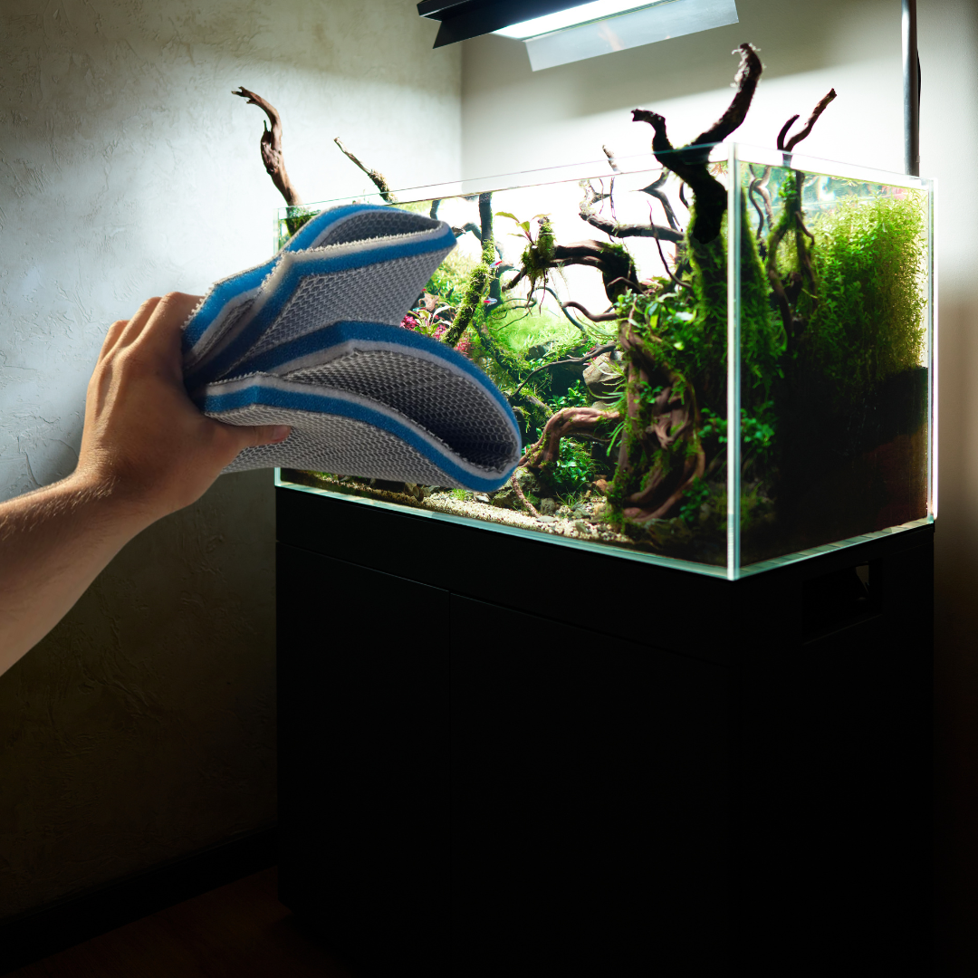 Nano Clean XD filter pad held beside a planted aquarium